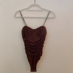 brown ruffle body suit with studded straps